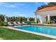 Backyard featuring a beautiful pool, lounge chairs, green grass and landscaping at 2339 E Virgo Pl, Chandler, AZ 85249