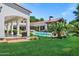 Backyard with a pool, patio, and lush green grass and plantings surrounding the pool at 2339 E Virgo Pl, Chandler, AZ 85249