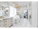 Elegant bathroom featuring marble floors, a chandelier, and double vanities with gold fixtures at 2339 E Virgo Pl, Chandler, AZ 85249