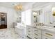 Elegant bathroom featuring marble floors, a chandelier, and double vanities with gold fixtures at 2339 E Virgo Pl, Chandler, AZ 85249