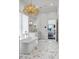 Bright bathroom features marble floors, a chandelier, and a modern white soaking tub at 2339 E Virgo Pl, Chandler, AZ 85249