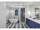 Luxurious bathroom with a soaking tub, glass-enclosed shower, and marble accents at 2339 E Virgo Pl, Chandler, AZ 85249