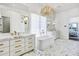 Elegant bathroom featuring marble floors, a chandelier, and double vanities with gold fixtures at 2339 E Virgo Pl, Chandler, AZ 85249