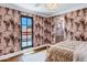 Charming bedroom features patterned wallpaper, a black-framed door, and a sunlit view at 2339 E Virgo Pl, Chandler, AZ 85249