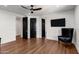 Spacious bedroom has hardwood floors, modern ceiling fan, and multiple black paneled doors at 2339 E Virgo Pl, Chandler, AZ 85249