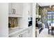 Bright butler's pantry featuring white cabinets, marble counters, and gold hardware, connecting to dining area at 2339 E Virgo Pl, Chandler, AZ 85249