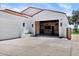 Exterior of a white home featuring a garage and a wood-paneled garage with black ceiling and copper lighting at 2339 E Virgo Pl, Chandler, AZ 85249