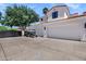 Home exterior featuring white garages and large driveway with a golf cart parked on it at 2339 E Virgo Pl, Chandler, AZ 85249