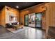 The flex room showcases wood paneling, a leather sofa, black ceilings, and a view to the backyard at 2339 E Virgo Pl, Chandler, AZ 85249