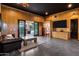 Flex room features wood paneling, a leather sofa and a view to the backyard at 2339 E Virgo Pl, Chandler, AZ 85249