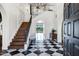 Stunning foyer features a black and white checkerboard floor, a staircase and a view to the pool area at 2339 E Virgo Pl, Chandler, AZ 85249