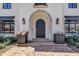 Elegant front entrance features a classic arched doorway and decorative flower planters at 2339 E Virgo Pl, Chandler, AZ 85249