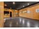 This is a spacious garage with a black ceiling, wood-paneled walls, storage, and overhead copper lighting at 2339 E Virgo Pl, Chandler, AZ 85249