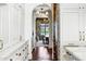 Hallway featuring marble counters, brass hardware, and views into the dining room with a vintage-style table at 2339 E Virgo Pl, Chandler, AZ 85249