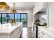 Open kitchen with marble island and double sinks, connecting to an outdoor patio at 2339 E Virgo Pl, Chandler, AZ 85249