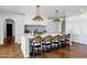 Kitchen island featuring marble counters, barstool seating, and brass pendant lights, perfect for cooking and entertaining at 2339 E Virgo Pl, Chandler, AZ 85249