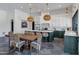 Open-concept kitchen featuring a central island, stylish pendant lighting, and a dining area with seating for a casual dining experience at 2339 E Virgo Pl, Chandler, AZ 85249