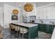 A gourmet kitchen with a large marble island, custom green cabinets and professional grade stainless steel appliances at 2339 E Virgo Pl, Chandler, AZ 85249