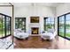 Bright living room features a stone fireplace, herringbone floors and two chaise lounges at 2339 E Virgo Pl, Chandler, AZ 85249