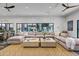 Open living room showcases an oversized sectional, a patterned rug, and views of the backyard beyond the floor-to-ceiling windows at 2339 E Virgo Pl, Chandler, AZ 85249