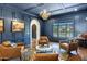 Elegant living room featuring a coffered ceiling, hardwood floors, leather chairs and an ornate chandelier at 2339 E Virgo Pl, Chandler, AZ 85249