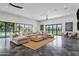 Spacious living room featuring a large sectional sofa, stylish rug, and floor-to-ceiling windows offering great natural light at 2339 E Virgo Pl, Chandler, AZ 85249