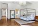 Elegant main bedroom with herringbone floors, statement mirror, chandelier and ensuite bathroom at 2339 E Virgo Pl, Chandler, AZ 85249