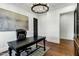 Bright office with chandelier, dark desk and chair, light walls and herringbone floors at 2339 E Virgo Pl, Chandler, AZ 85249