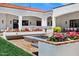 Outdoor kitchen with built-in grill and ample counter space, surrounded by colorful flowers and lush greenery at 2339 E Virgo Pl, Chandler, AZ 85249