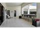 Covered patio features an outdoor bar with seating, bright white tile flooring, and comfortable lounge furniture at 2339 E Virgo Pl, Chandler, AZ 85249
