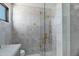 Bathroom showcases modern shower with sleek tiling, a gold shower system, and glass door at 2339 E Virgo Pl, Chandler, AZ 85249