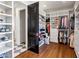Spacious walk-in closet with custom shelving, drawers, and hardwood flooring at 2339 E Virgo Pl, Chandler, AZ 85249