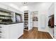 Spacious walk-in closet with custom shelves, cabinets, marble countertops and hardwood floors at 2339 E Virgo Pl, Chandler, AZ 85249