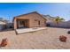 This backyard features gravel landscaping, a privacy fence, and a covered patio at 23676 W Parkway Dr, Buckeye, AZ 85326