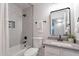 This bathroom features neutral paint, tub, shower, and framed mirror over a grey vanity at 23676 W Parkway Dr, Buckeye, AZ 85326