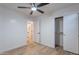 This bedroom features neutral paint, wood-look floors, and ceiling fan with closet and bathroom access at 23676 W Parkway Dr, Buckeye, AZ 85326