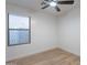 Bedroom featuring hardwood floors, a ceiling fan, and generous natural light at 23676 W Parkway Dr, Buckeye, AZ 85326