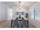 Formal dining room showcasing modern light fixture, marble table, and neutral accents at 23676 W Parkway Dr, Buckeye, AZ 85326