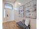 Bright foyer with wood flooring, neutral walls, and a bench below modern art at 23676 W Parkway Dr, Buckeye, AZ 85326