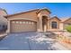 Charming single-level home with a two-car garage and desert landscaping with a well maintained driveway at 23676 W Parkway Dr, Buckeye, AZ 85326