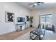 Contemporary living room featuring a TV, sleek furniture, and sliding doors to the outdoor space at 23676 W Parkway Dr, Buckeye, AZ 85326