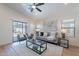 Stylish living room with a plush sofa, modern decor, and sliding doors to the backyard at 23676 W Parkway Dr, Buckeye, AZ 85326