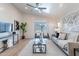 Bright living room featuring stylish decor, neutral tones, and access to the outdoor patio at 23676 W Parkway Dr, Buckeye, AZ 85326