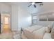 Bright main bedroom with a walk-in closet, neutral colors, wood floors, ceiling fan, and generous natural light at 23676 W Parkway Dr, Buckeye, AZ 85326