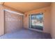This covered patio features a ceiling fan, access to the backyard, and decorative brick wall at 23676 W Parkway Dr, Buckeye, AZ 85326