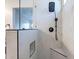 Spacious modern tiled shower featuring a black shower head and hardware with a window at 23676 W Parkway Dr, Buckeye, AZ 85326