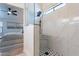 Modern tiled shower with black hardware and an adjoining bedroom at 23676 W Parkway Dr, Buckeye, AZ 85326