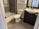 This bathroom features a tub with glass door, modern vanity, and updated fixtures at 244 E Ponderosa Ln, Phoenix, AZ 85022