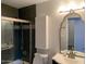 This bathroom is equipped with a glass-enclosed shower, mirrored vanity, and modern fixtures at 244 E Ponderosa Ln, Phoenix, AZ 85022