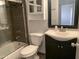 This bathroom is complete with a tub, glass door shower, toilet, vanity, and medicine cabinet at 244 E Ponderosa Ln, Phoenix, AZ 85022